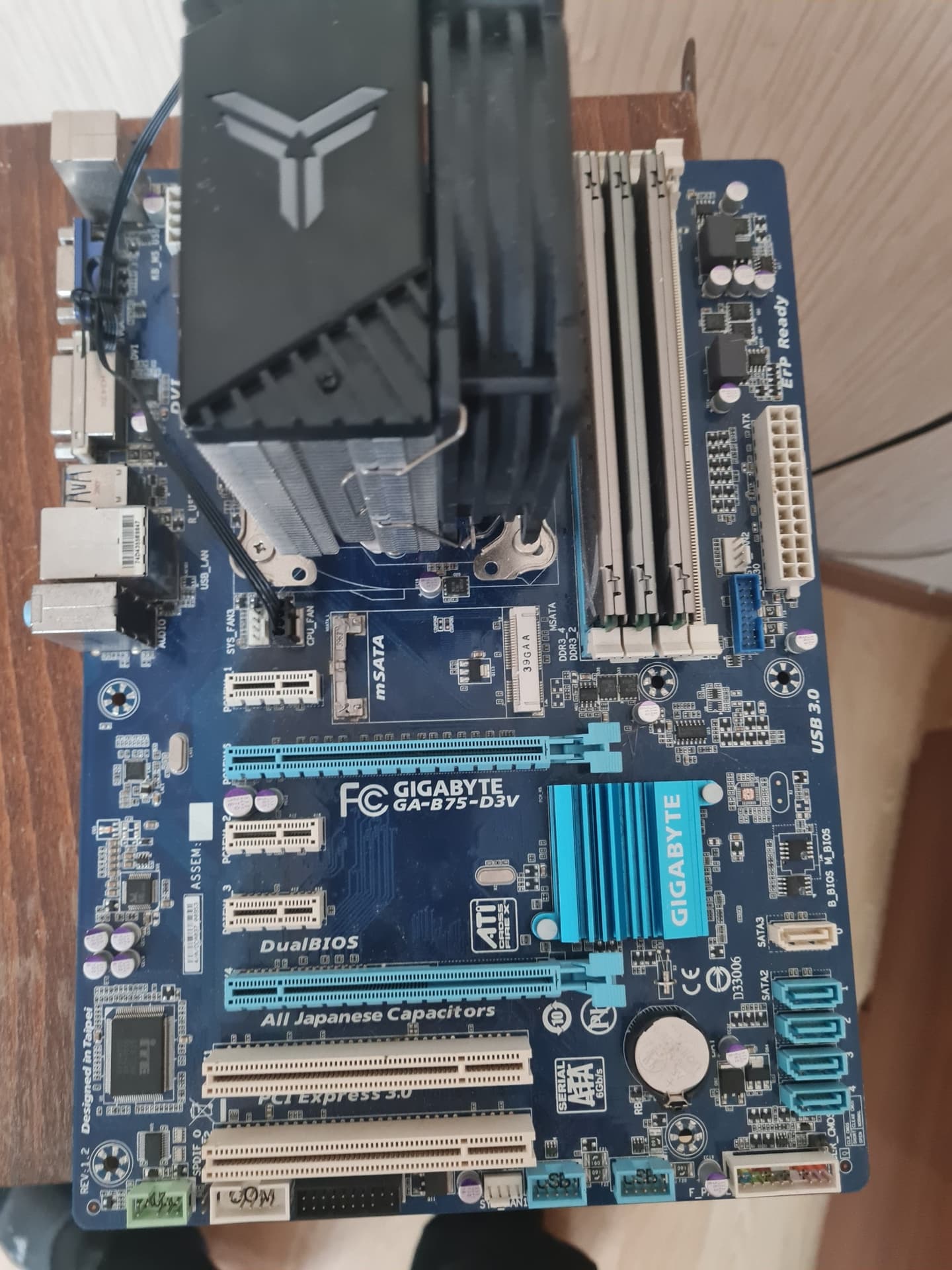 Материнская плата Gigabyte GA-B75-D3V с кулером и четырьмя планками оперативной памяти.