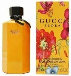 Флакон духов Gucci Flora и их упаковка с цветочным дизайном.